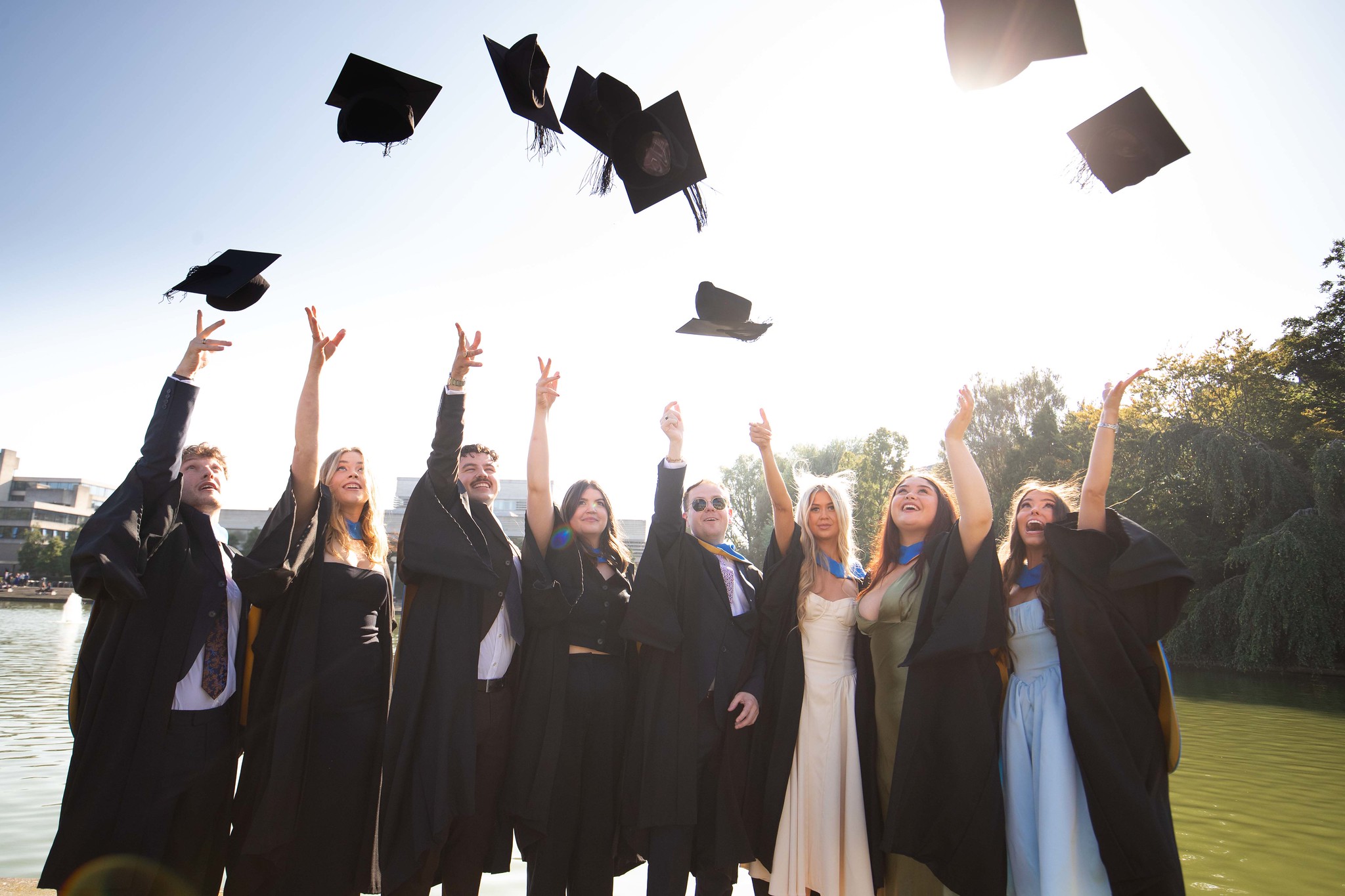 Group of graduates throwing their hats in the air