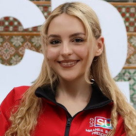 Woman with blonde hair and a red jacket.