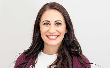 Women with brown hair smiling.