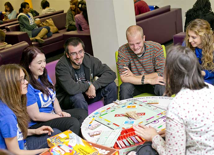 A group of students play monopoly.