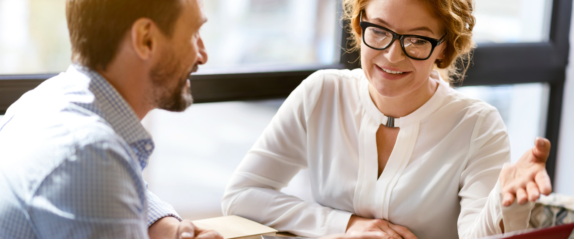 Image of two staff talking