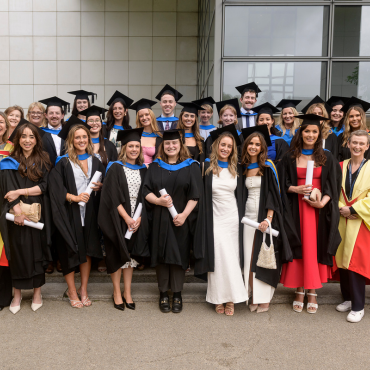 UCD graduate class in caps and gowns