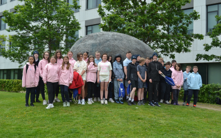 Group of school students standing in front of sculpture at UCD