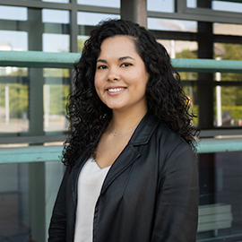 A woman smiling to the camera.