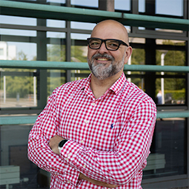 A man smiling to the camera.