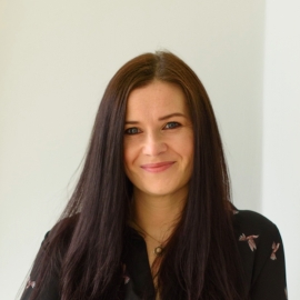 A woman smiling to the camera.